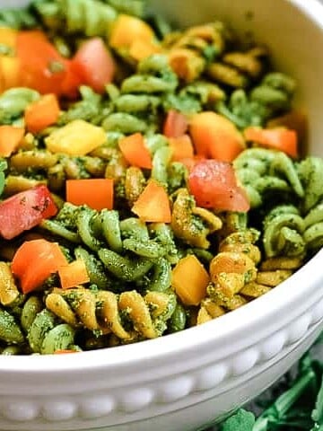 Fresh and peppery, this vegan pesto pasta made with arugula and basil packs a flavorful punch. It's a delicious alternative to the typical white pasta recipes with the substitution of lentil pasta for added protein.