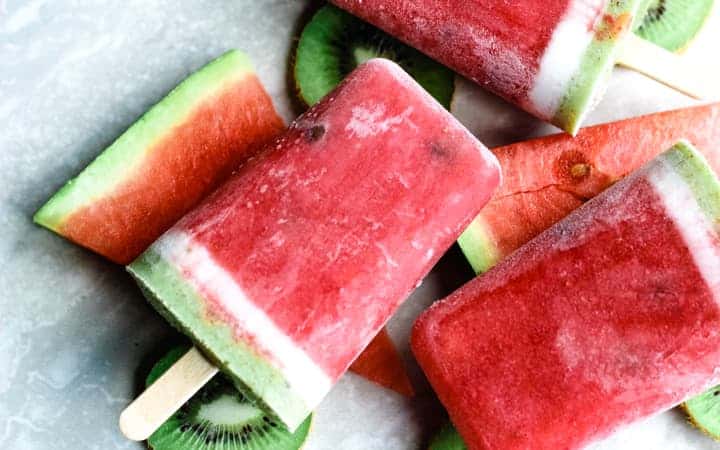 watermelon popsicles on top of watermelon and kiwi slices