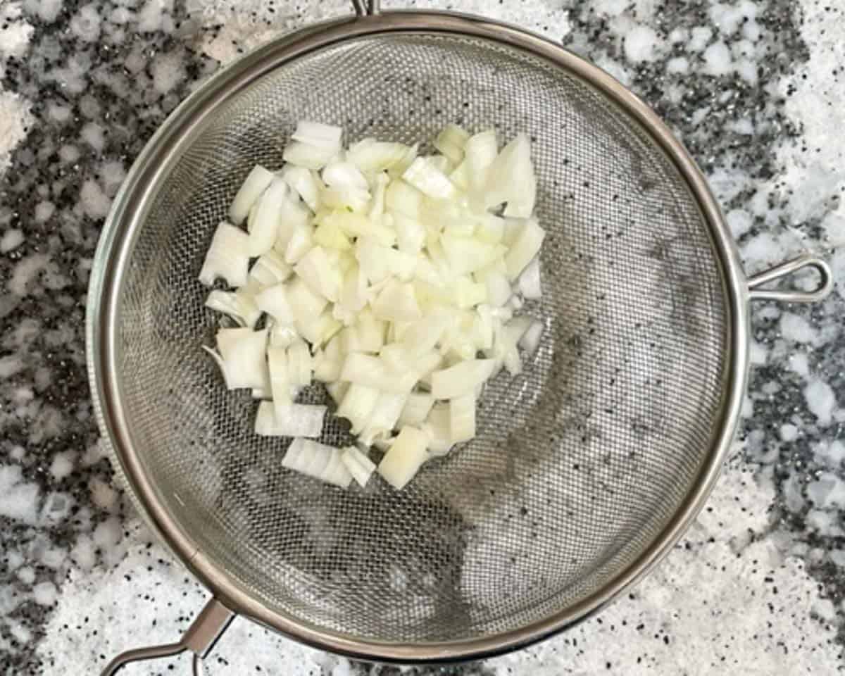 White onions in strainer.