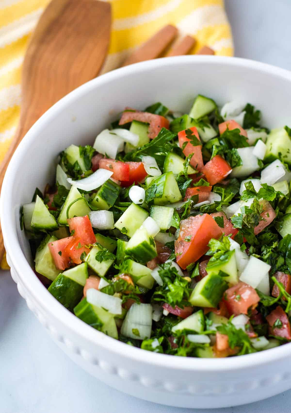 close up overhead of cucumber salad in white bowl