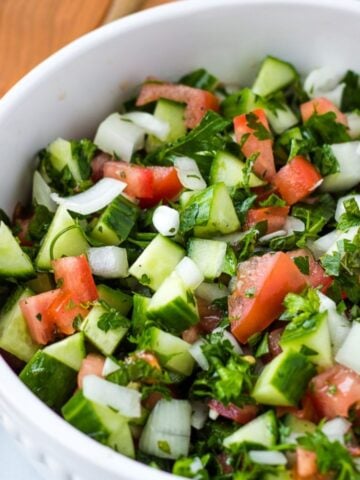 Mediterranean Cucumber salad in white serving bowl.