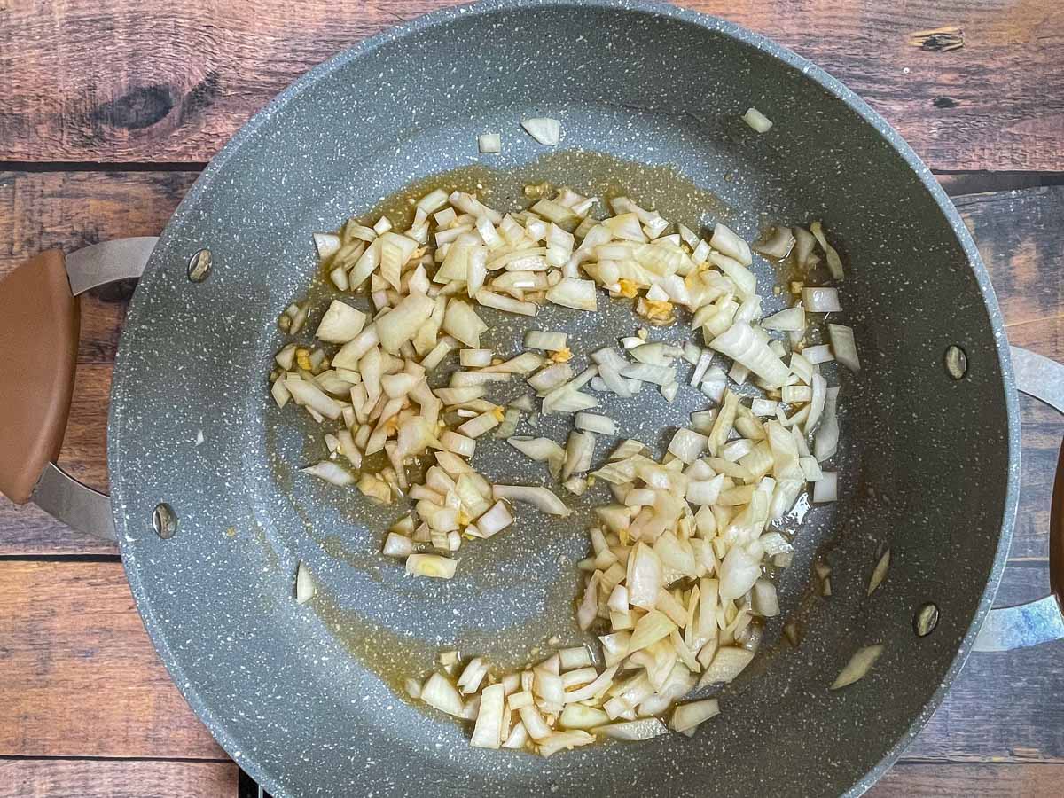 Diced onions and garlic in Dutch oven.
