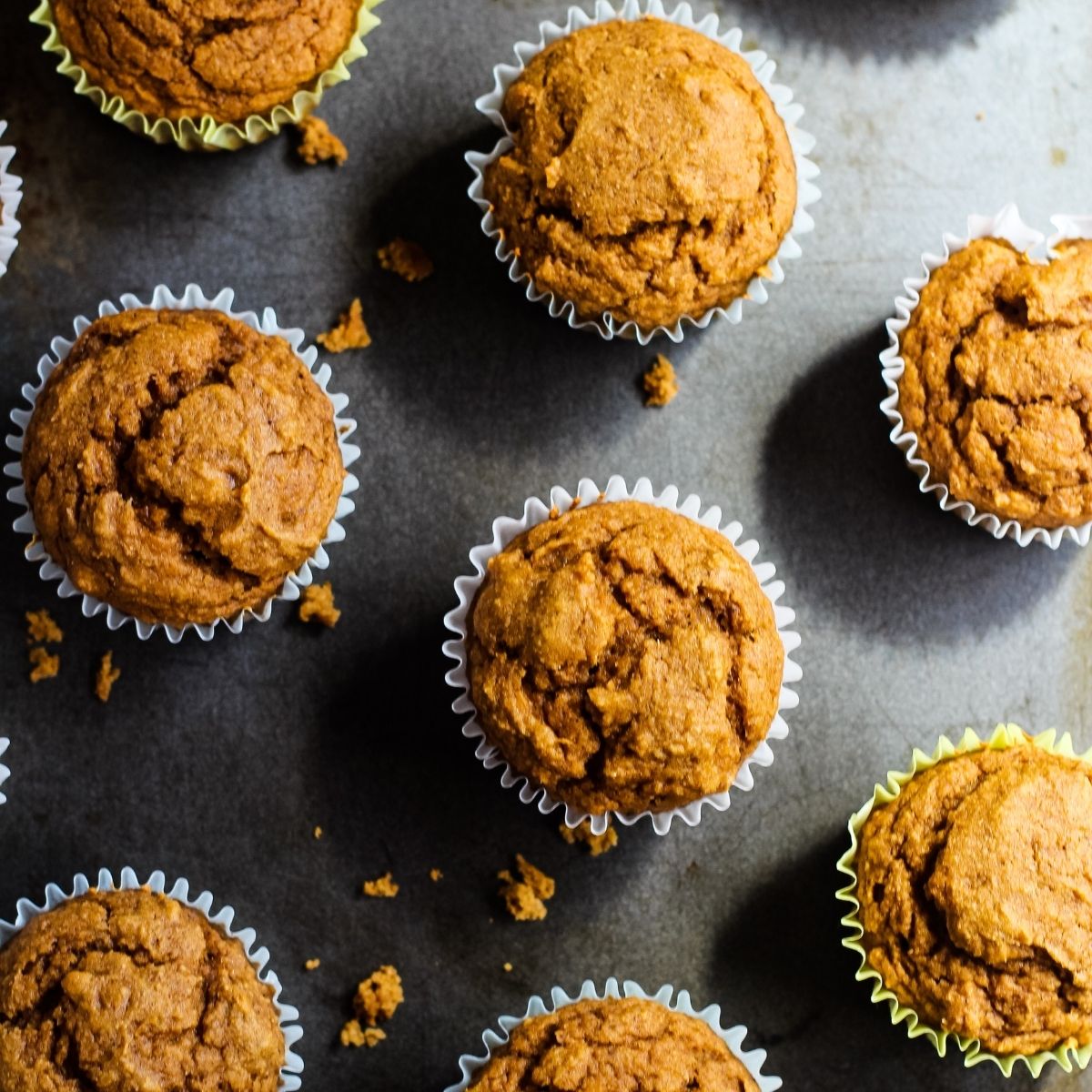 Vegan pumpkin muffins on baking sheet.