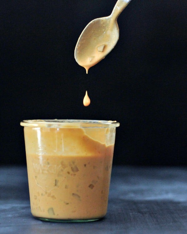 vegan thousand island dressing in glass jar with dipped spoon