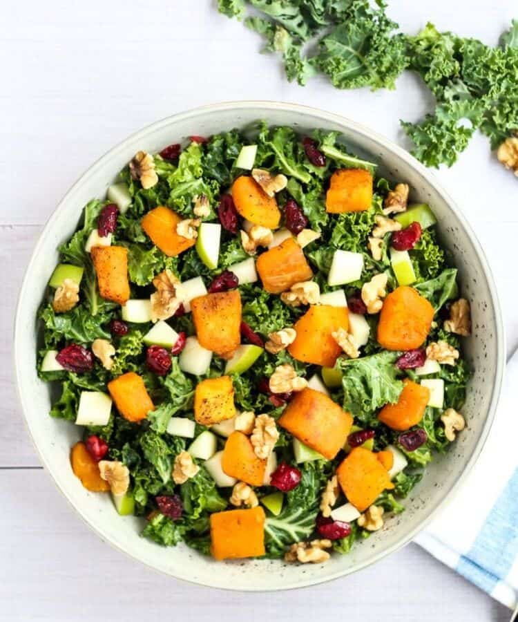 kale salad with butternut squash, cranberries, apples, and walnuts