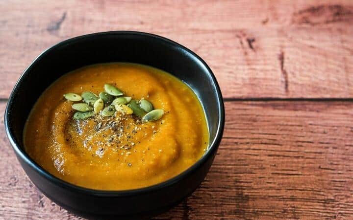 vegan pumpkin soup in black bowl