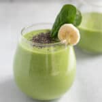 Spinach apple smoothie in glass.