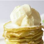 Stack of apple chips topped with vanilla ice cream.