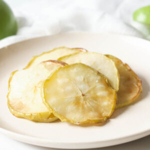 White plate of apple chips.