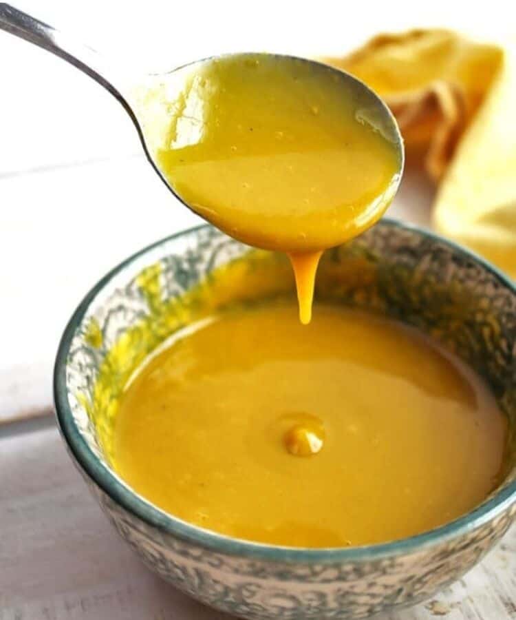 vegan honey mustard dressing with spoon dipped 