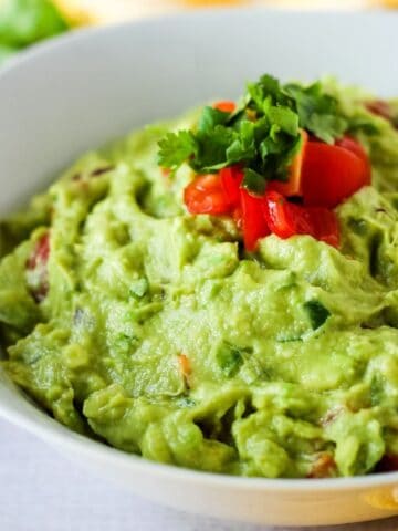 4 Ingredient guacamole in white bowl.