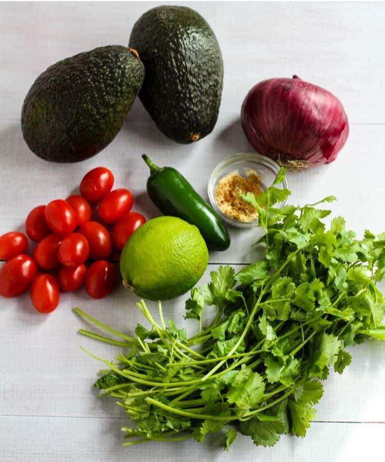 4 ingredient guacamole ingredients: avocados, red onion, tomatoes, jalapeño, lime, spices.