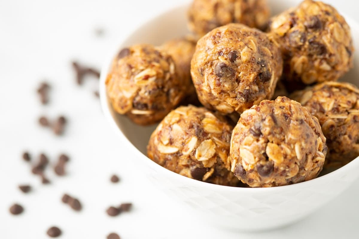 Vegan protein balls in a small white serving bowl.
