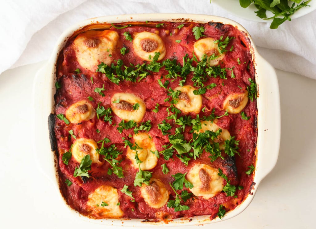 baked vegetable lasagna topped with chopped parsley