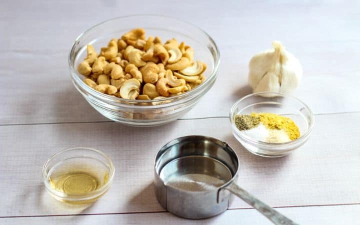 cashews, garlic, apple cider vinegar, water, and spices on counter top