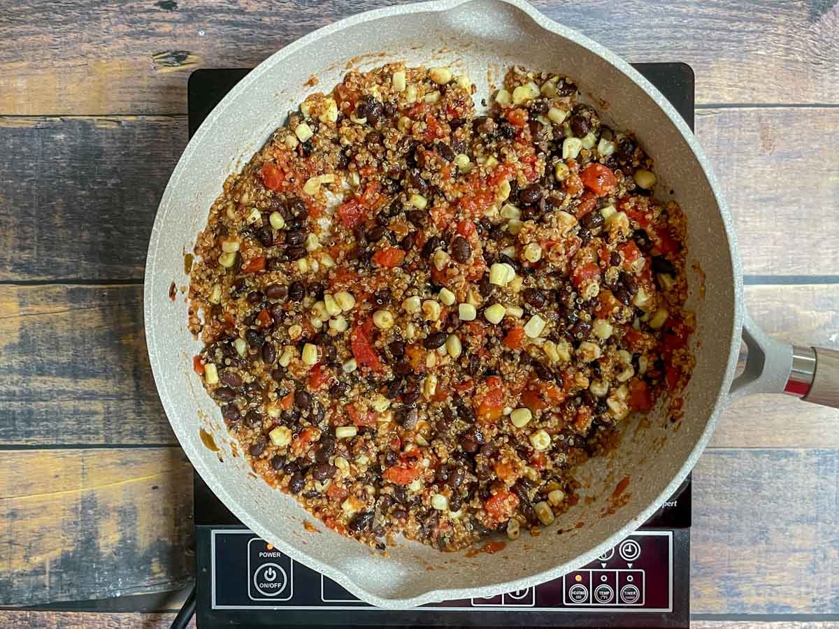 Quinoa and black bean mixture in a saute pan.