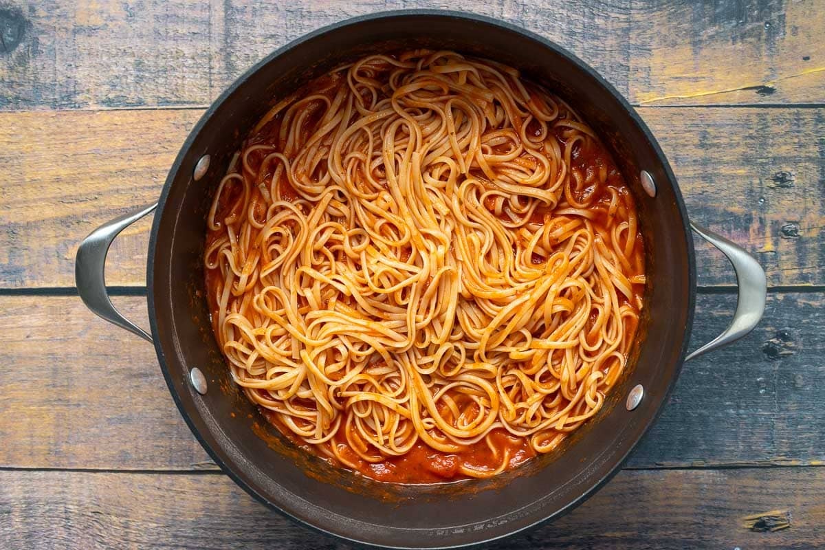 Spaghetti in marinara sauce in pot.