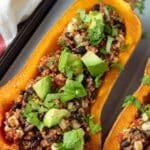 Vegan stuffed butternut squash with quinoa black beans and avocado.