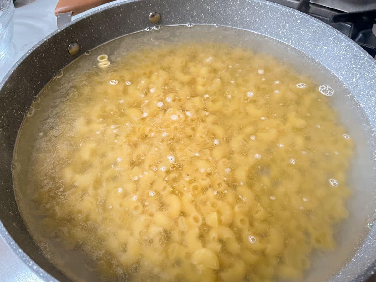 Macaroni boiling in pot of water.