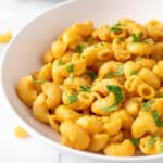 Vegan butternut squash mac and cheese topped with parsley.