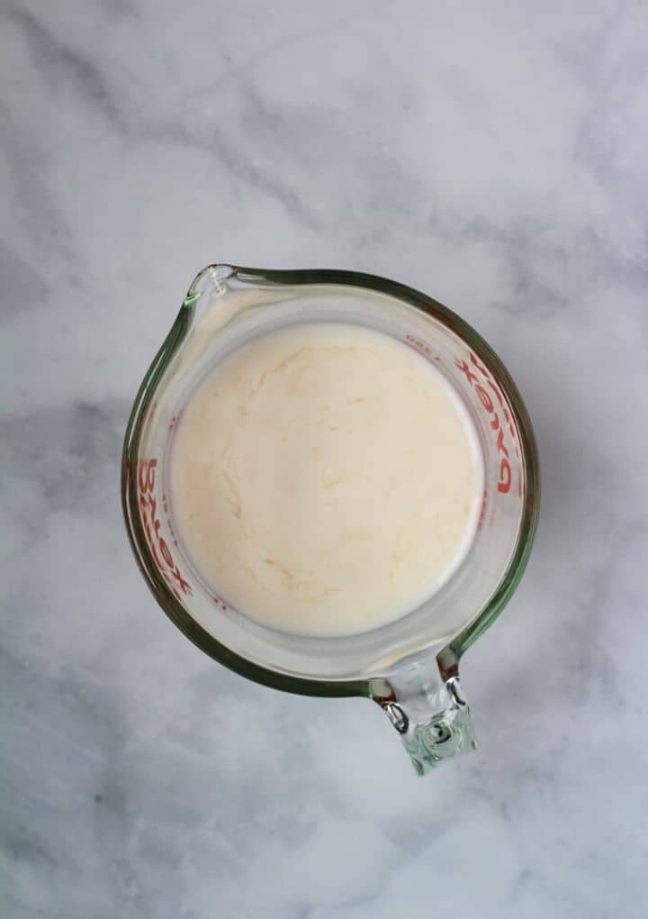 Dairy free milk and vinegar combined in pyrex measuring cup.