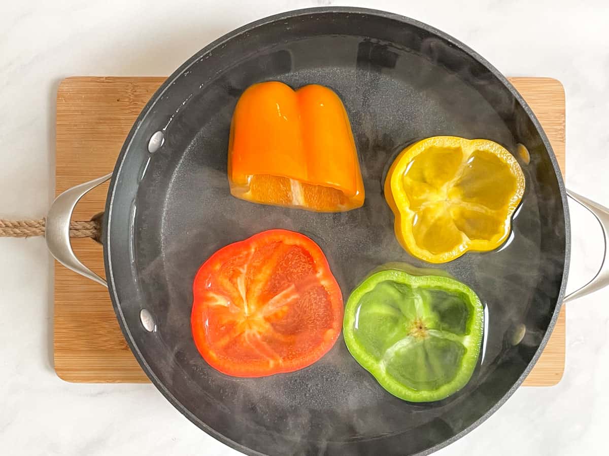 Colorful peppers in boiling water.
