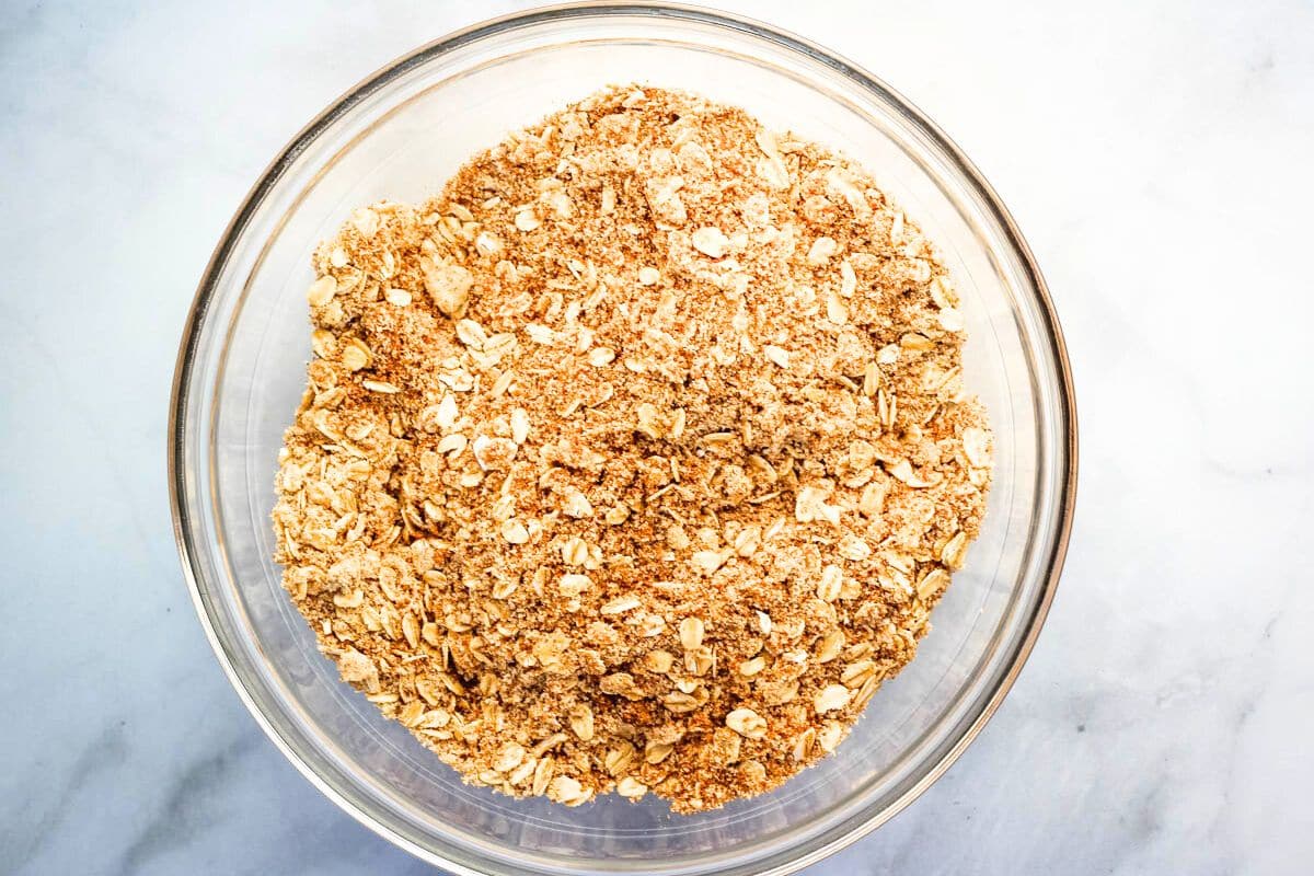 Oats and almond flour whisked together in a glass bowl.