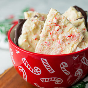 Vegan peppermint bark pieces in candy cane bowl.
