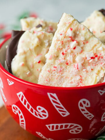 Vegan peppermint bark pieces in candy cane bowl.
