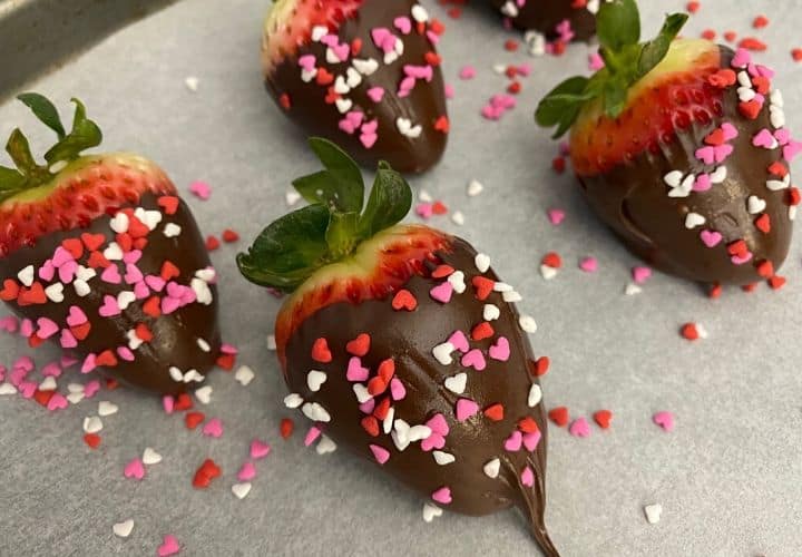 Vegan chocolate covered strawberries on parchment paper.