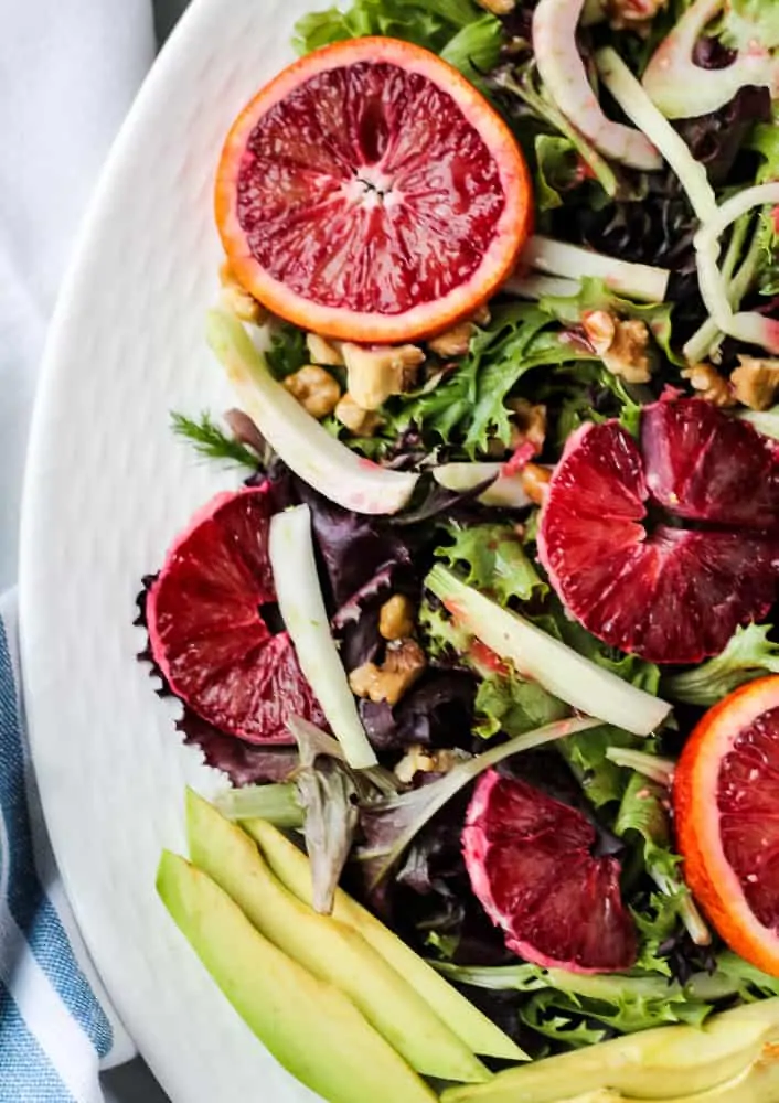 close up of blood oranges on a bed of greens