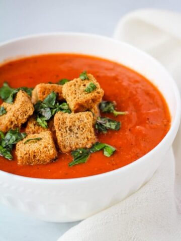 vegan tomato soup with croutons and basil