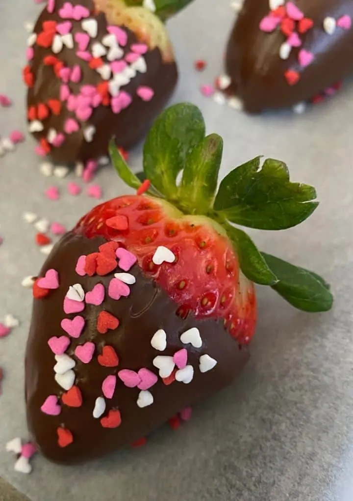 vegan chocolate covered strawberries on parchment paper
