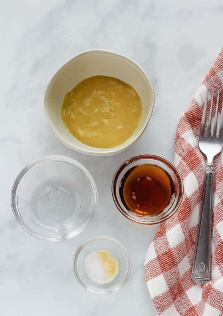 mustard, vinegar, salt, maple syrup in bowls