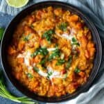 Lentil curry topped with cilantro and coconut cream.