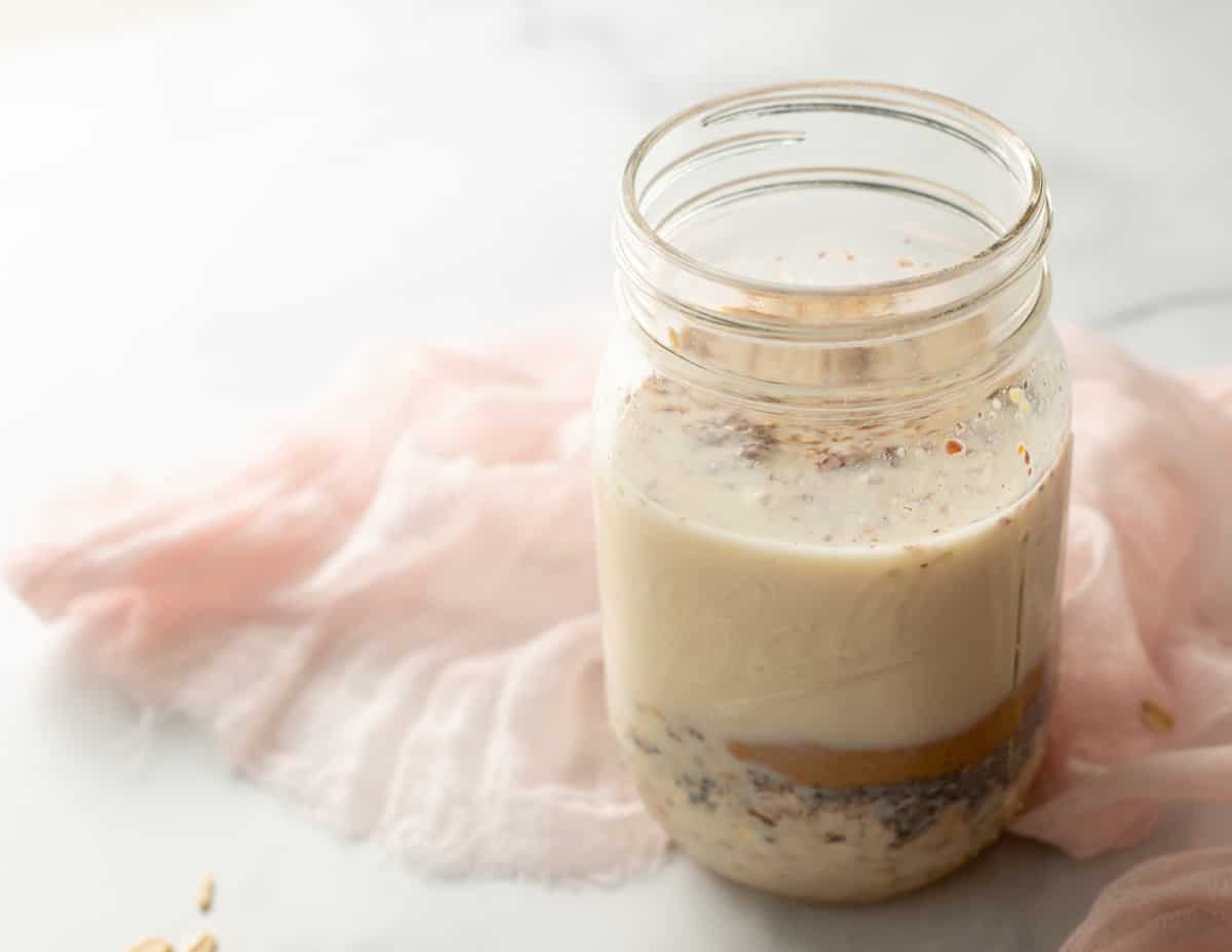 Almond milk, peanut butter, oats, flax and chia in mason jar. 
