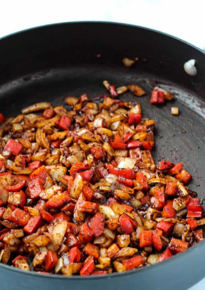onions, peppers, and spices in pan
