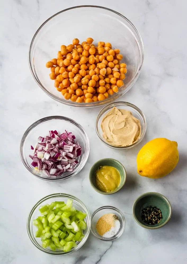 chickpeas celery, onions, lemon, hummus, and spices  in bowls