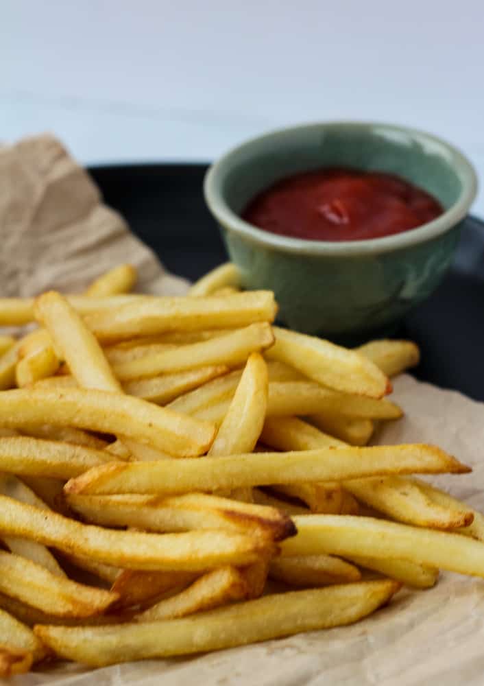 air fryer frozen french fries on paper bag with side of ketchup