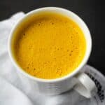 Turmeric latte in white mug.