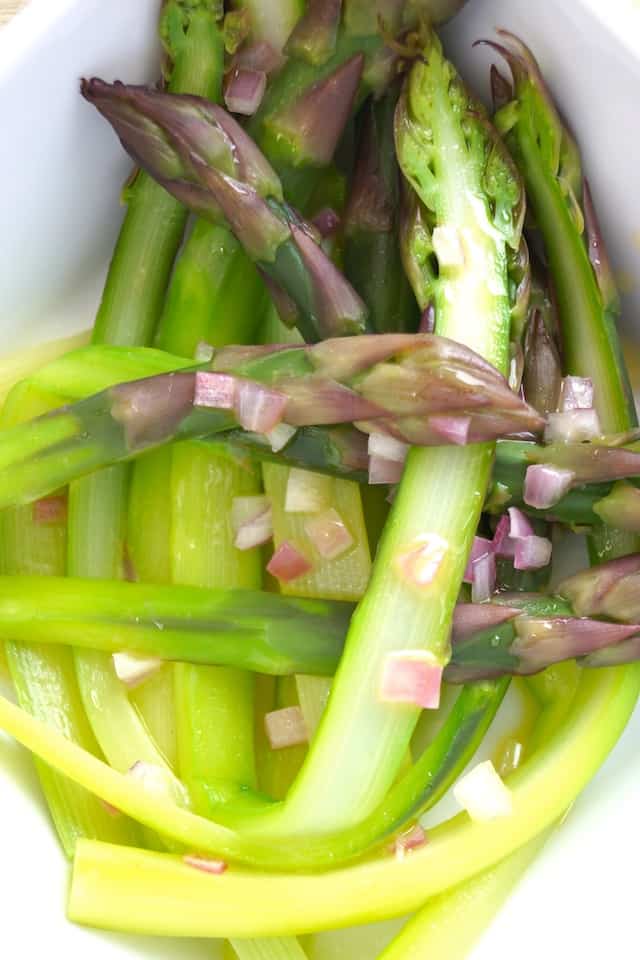 purple asparagus with chopped onion
