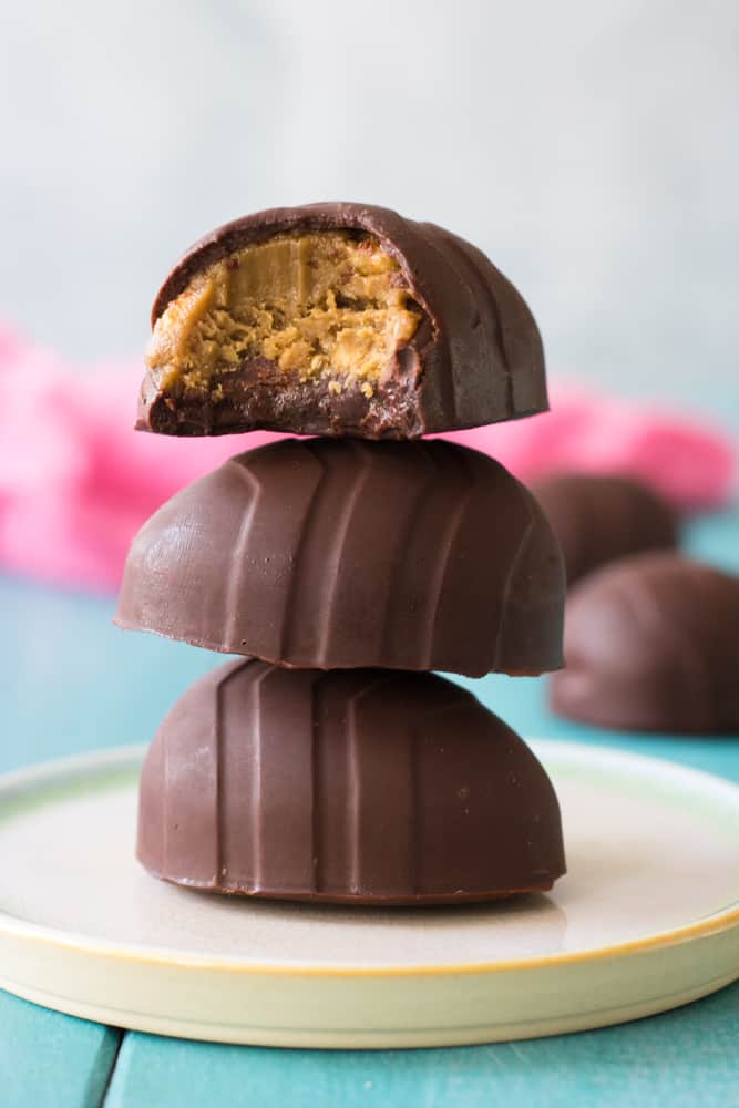 chocolate eggs filled with peanut butter stacked on top of one another