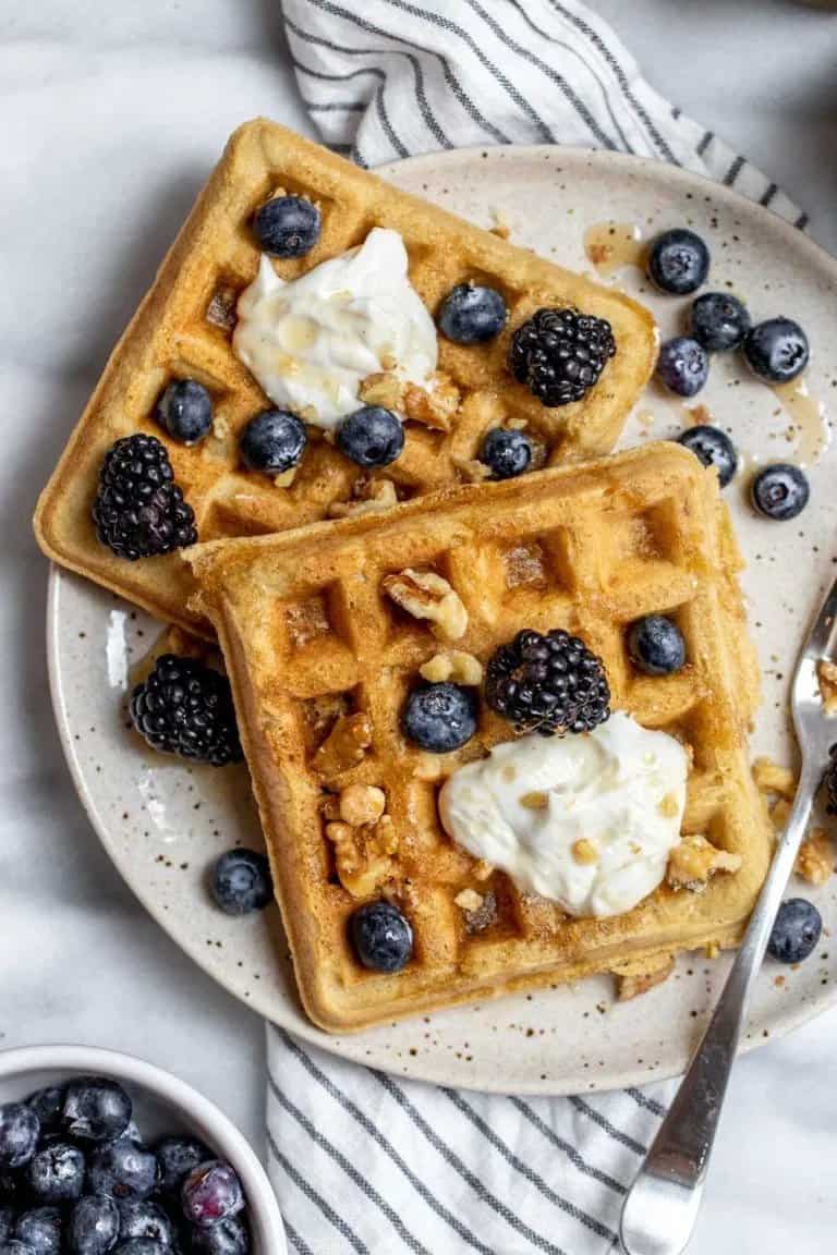 almond flour waffles topped with fresh berries and nuts