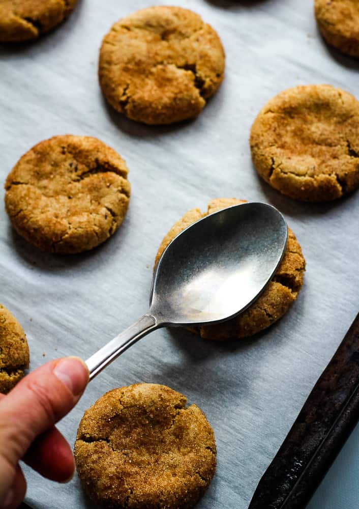 Pressing baked cookie with a spoon. 