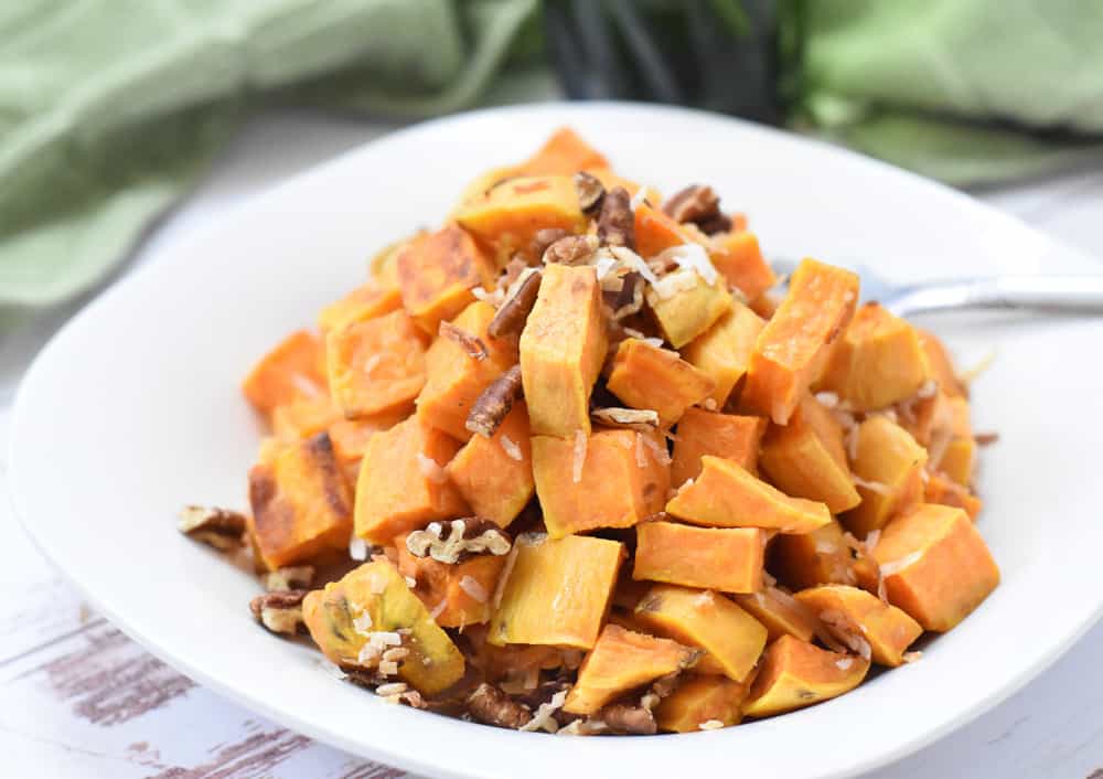 Crispy roasted sweet potatoes with pecan and coconut topping.