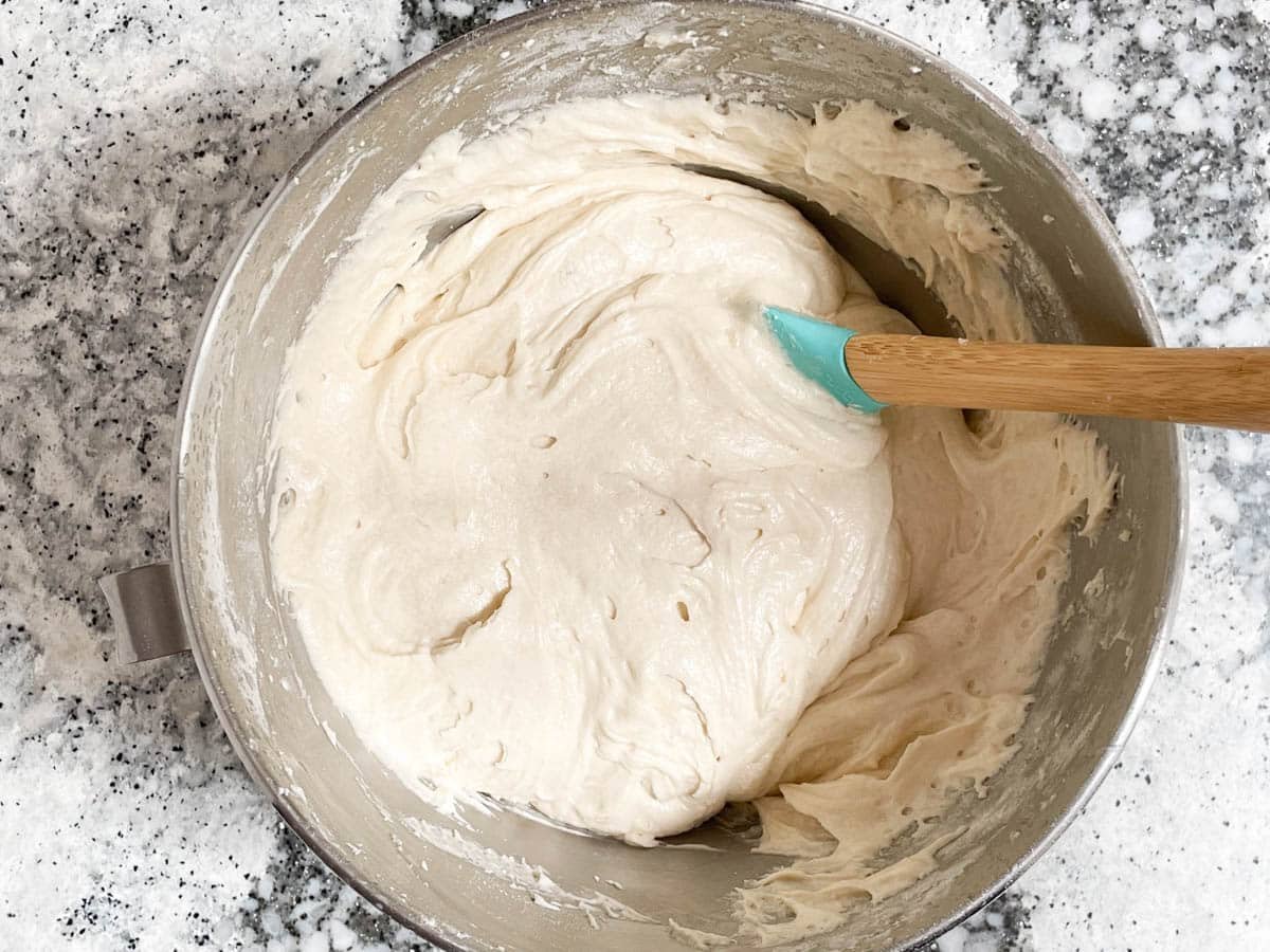 Lemon cake batter in mixing bowl with spatula.
