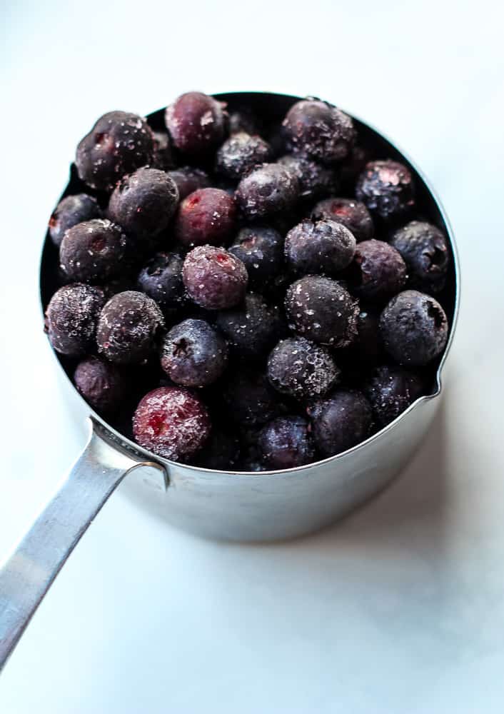 frozen blueberries in measuring cup