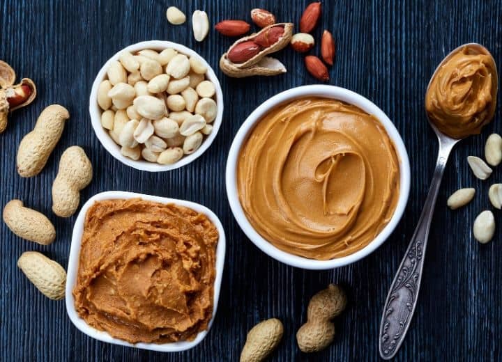 Creamy Peanut butter, peanuts, and crunchy peanut butter in bowls.

