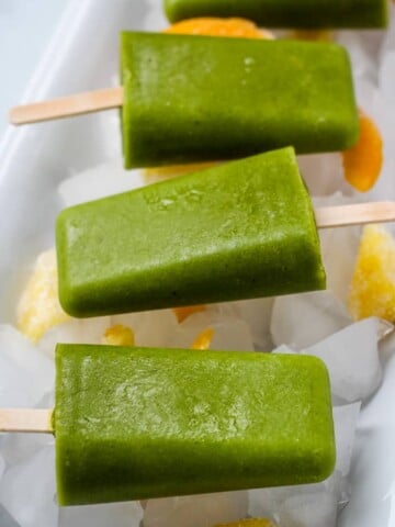 spinach mango popsicles on ice