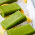 spinach mango popsicles on ice